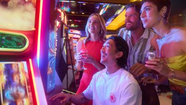 group gathered at slot machine