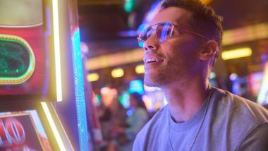 guy with sunglasses at a slot machine